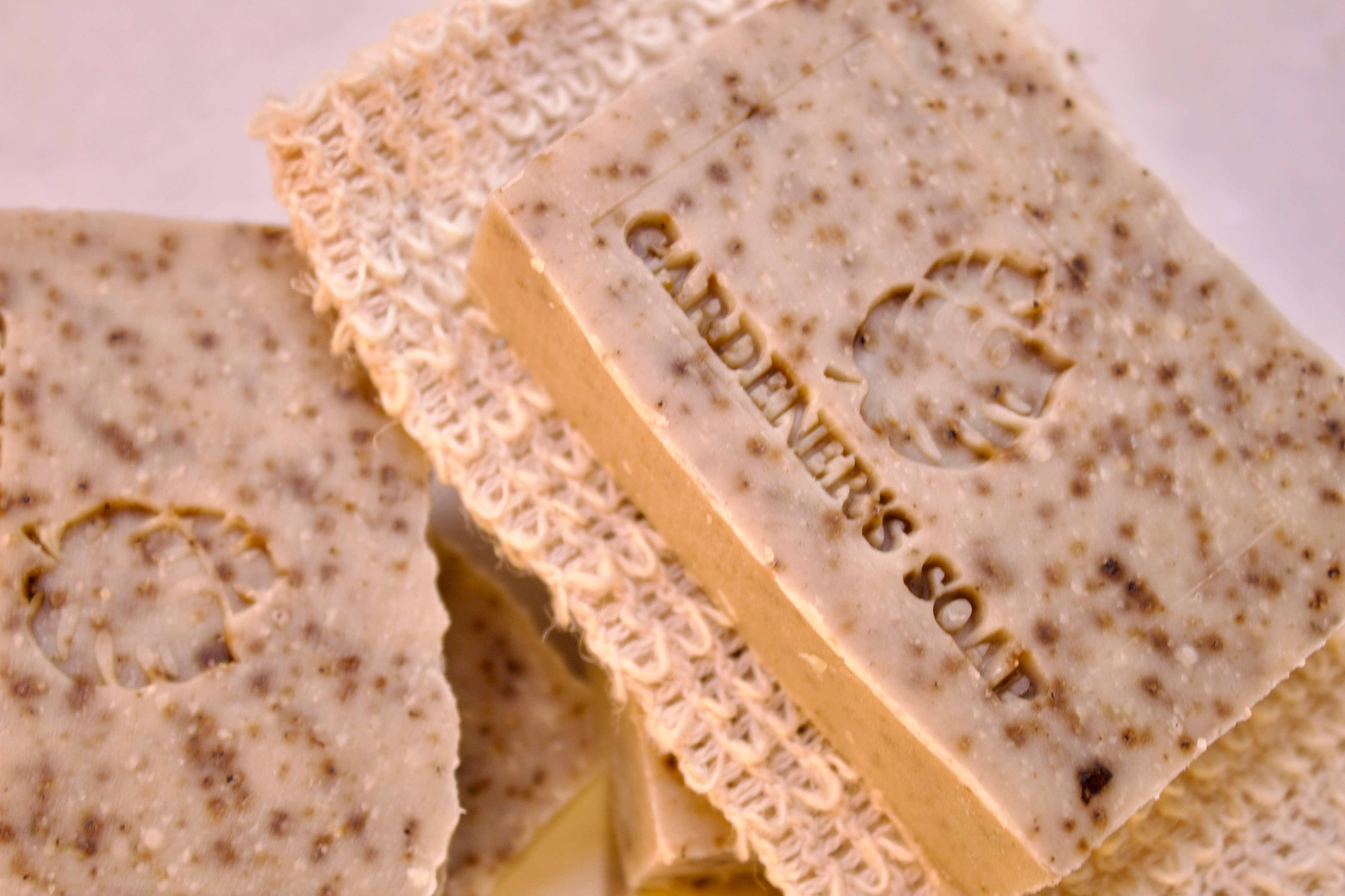 Close-up of a bar of handmade soap with visible texture and branding.