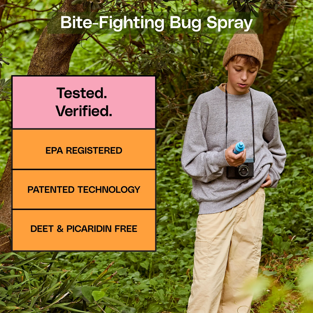 Person holding a bottle of bug spray with text about the product's features in a forest setting