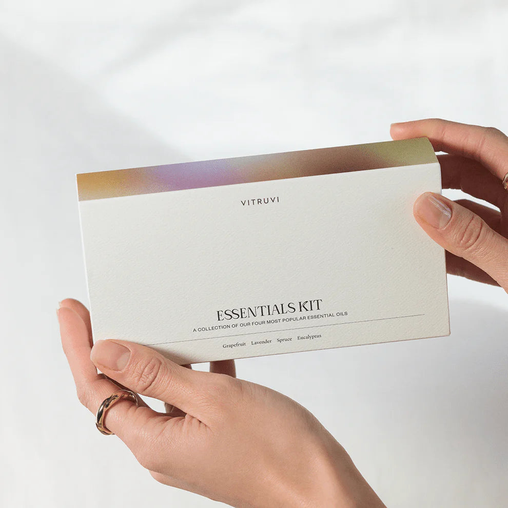 woman's hands holding essentials kit collection offer popular essential oils