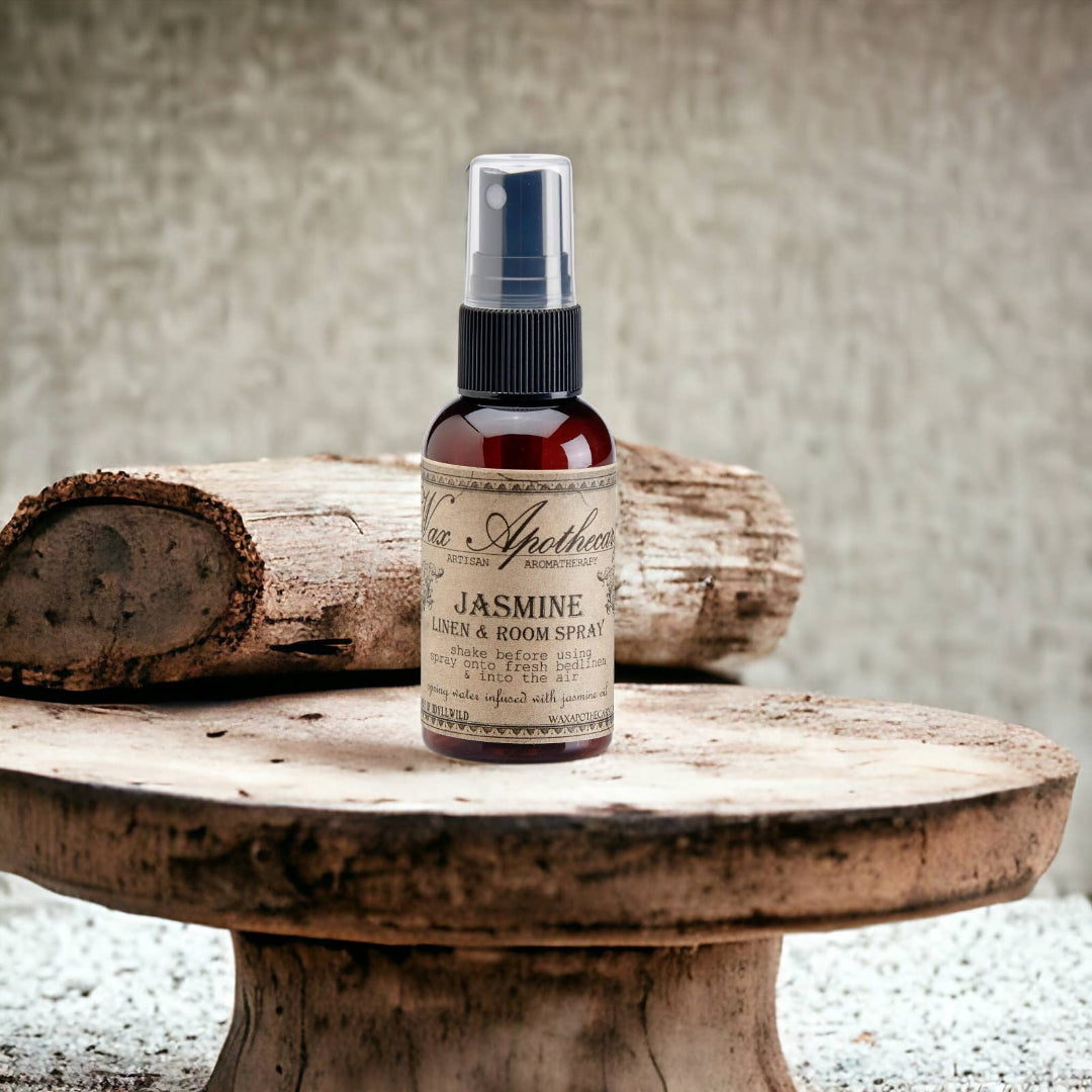 Bottle of Jasmine linen and room spray on a wooden surface with a rustic background