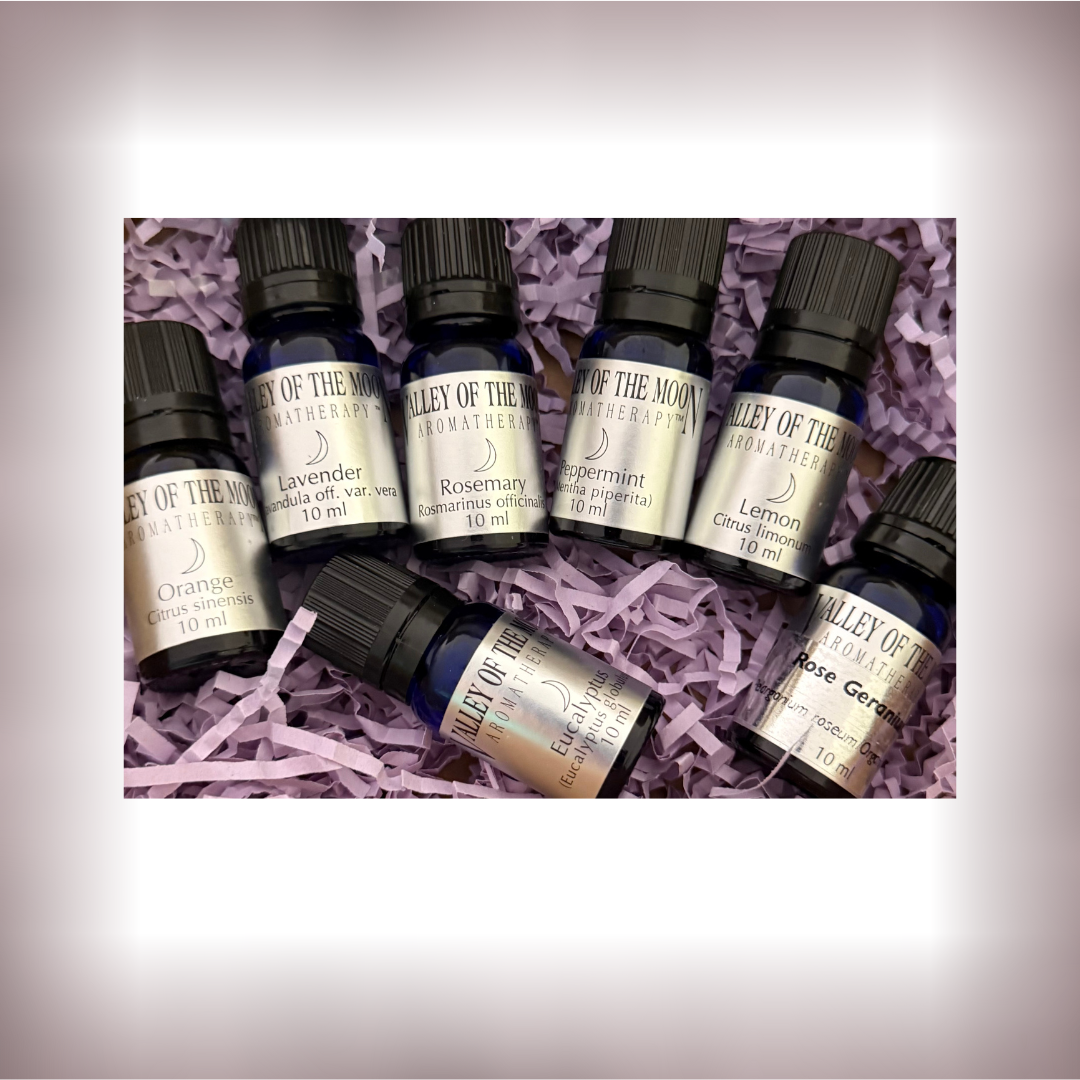 Set of 7 Valley of the Moon Aromatherapy essential oil bottles on purple shredded paper