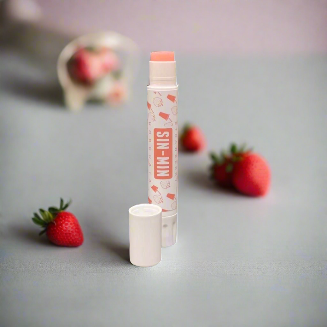 tube of pink strawberry sin min horchata lip balm